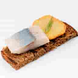 Borodino bread sandwich with french fries and salted herring fillets in oil.